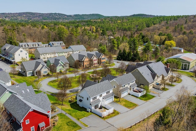 bird's eye view with a wooded view and a residential view
