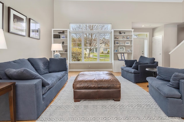 living area with light wood finished floors and baseboards