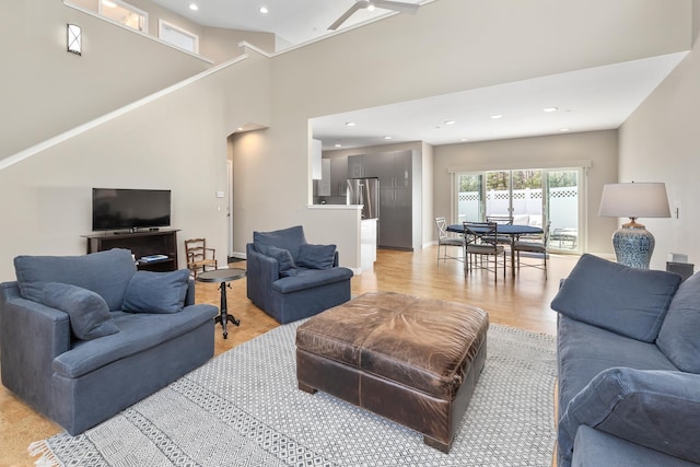 living area with light wood-style flooring and recessed lighting