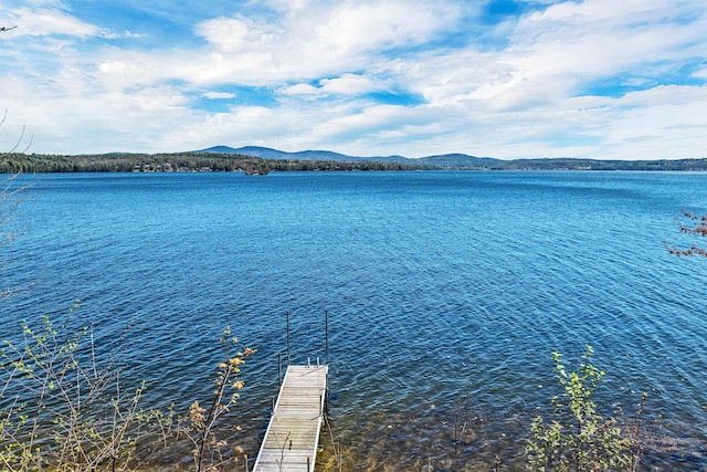 exterior space with a water and mountain view