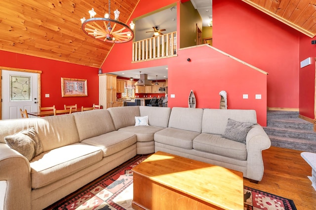 living room featuring wood finished floors, high vaulted ceiling, wooden ceiling, and ceiling fan with notable chandelier
