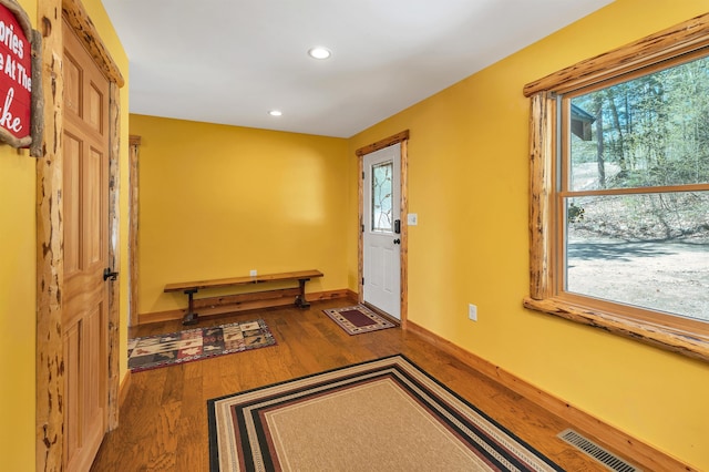 entryway featuring visible vents, wood finished floors, baseboards, and recessed lighting
