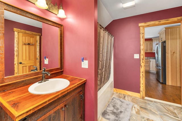full bathroom with baseboards, vanity, and shower / bath combo with shower curtain