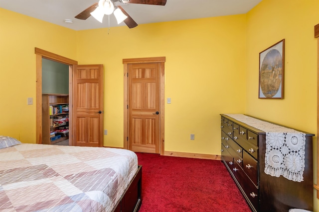 bedroom with dark colored carpet and a ceiling fan