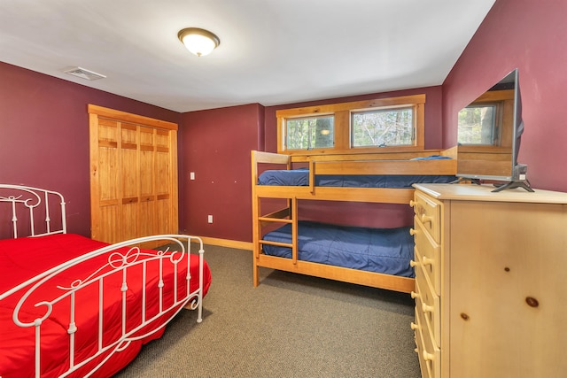 bedroom with a closet, visible vents, and carpet