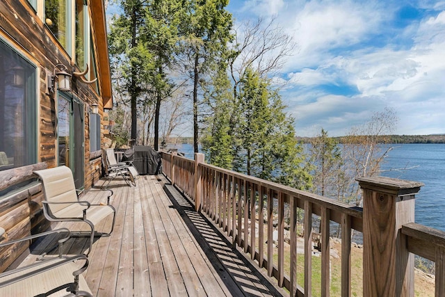 wooden deck featuring a water view and grilling area