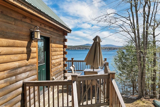 wooden terrace with a water and mountain view