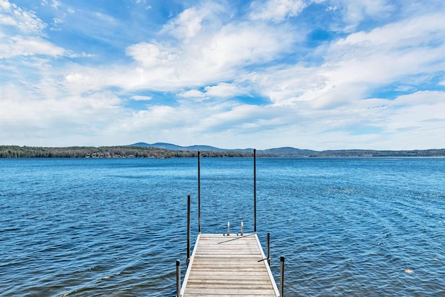 view of dock featuring a water and mountain view