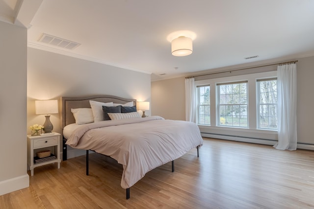 bedroom featuring crown molding, light wood-style flooring, a baseboard radiator, and visible vents