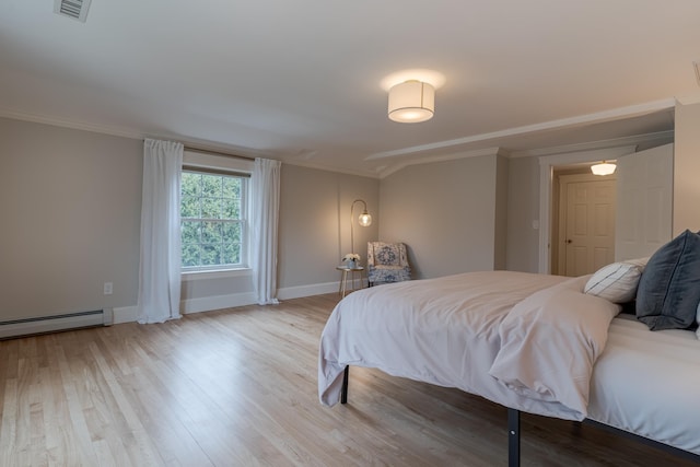 bedroom with a baseboard radiator, baseboards, ornamental molding, visible vents, and wood finished floors
