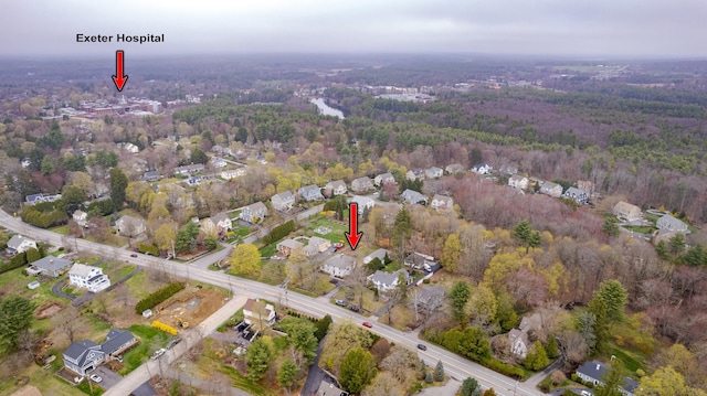 birds eye view of property with a residential view and a wooded view