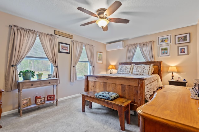 bedroom with carpet flooring, a wall mounted air conditioner, baseboards, and a ceiling fan