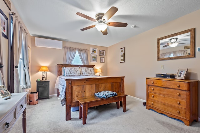 bedroom with ceiling fan, light carpet, a wall mounted AC, and baseboards