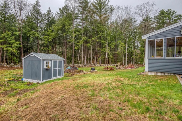 view of yard with a storage shed and an outbuilding