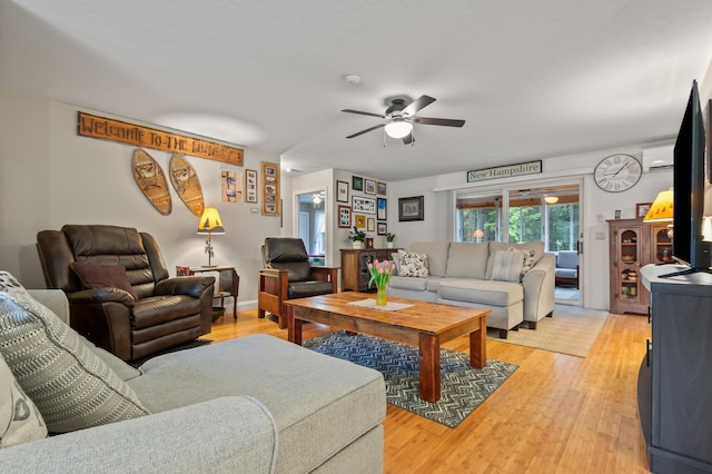 living area featuring ceiling fan and light wood finished floors