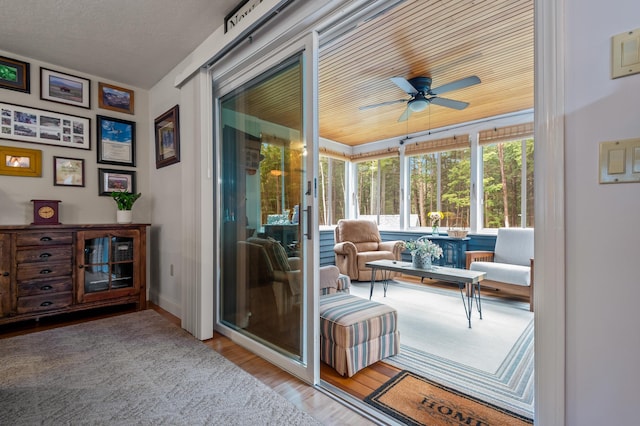 sunroom / solarium featuring ceiling fan