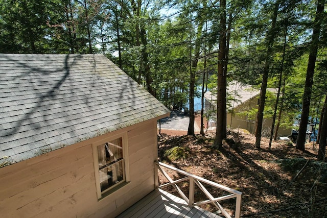 details featuring roof with shingles