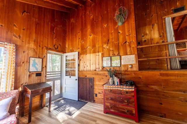 doorway to outside with wooden walls and wood finished floors