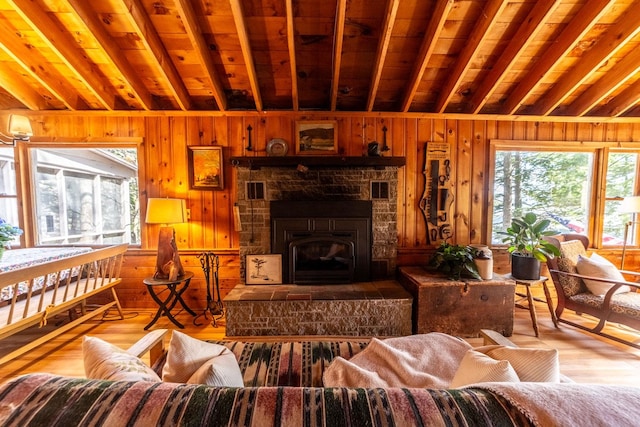 living area featuring wooden ceiling, wood walls, vaulted ceiling with beams, and wood finished floors