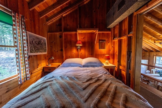 bedroom with wooden ceiling, wooden walls, and lofted ceiling with beams
