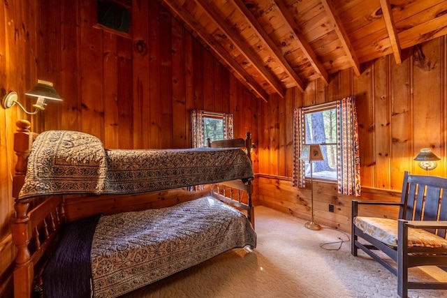bedroom featuring wooden ceiling, wood walls, carpet floors, and vaulted ceiling with beams