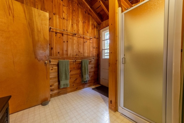 full bath with wood ceiling, tile patterned floors, wood walls, a shower stall, and lofted ceiling