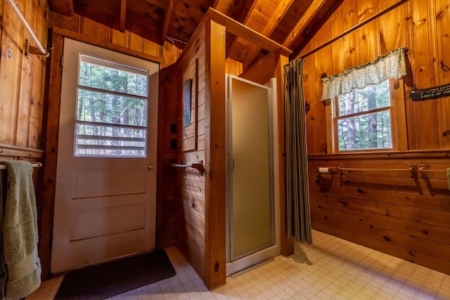 interior space featuring lofted ceiling, tile patterned floors, wood walls, and a shower stall