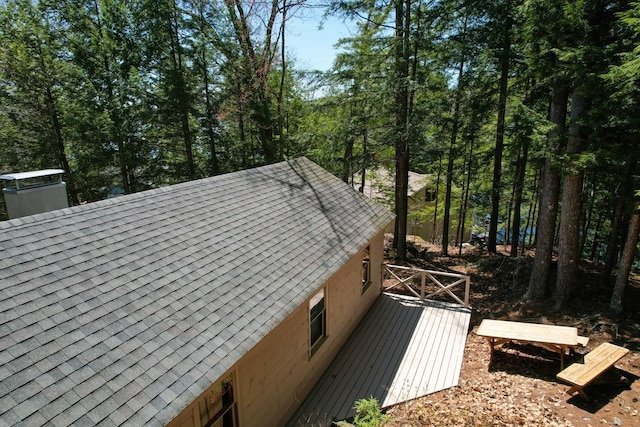 details with a shingled roof and a chimney