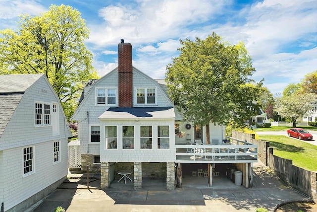 back of house with a patio, a chimney, and a wooden deck