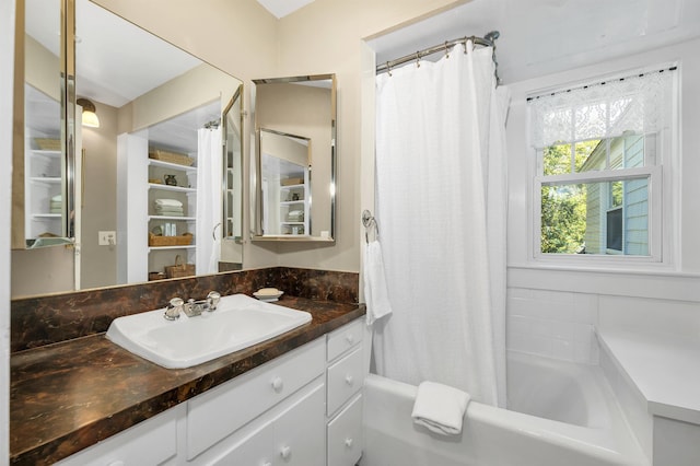full bathroom featuring shower / bath combination with curtain and vanity