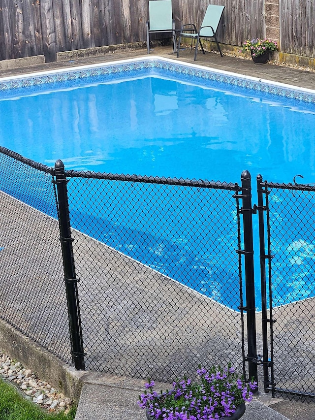 view of swimming pool featuring fence and a fenced in pool