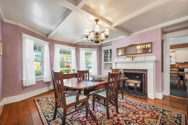 dining room with a fireplace, hardwood / wood-style floors, a notable chandelier, baseboards, and beamed ceiling