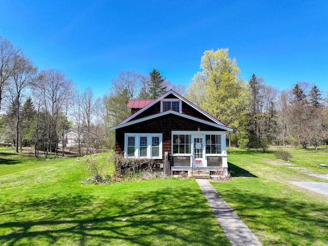 back of property featuring a lawn