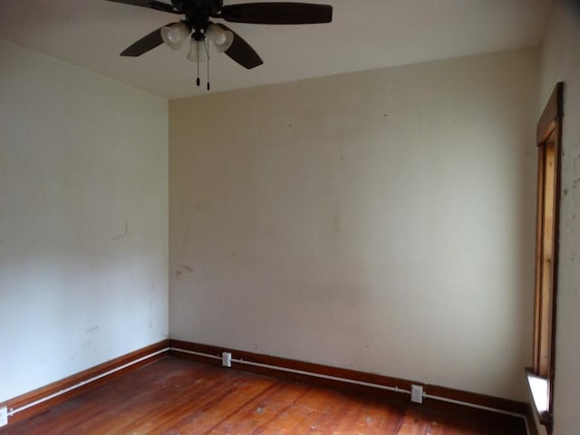 unfurnished room featuring baseboards, ceiling fan, and hardwood / wood-style flooring