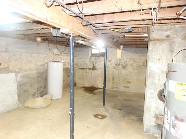 unfinished below grade area featuring water heater