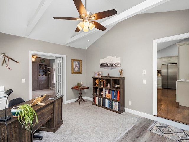 office area with baseboards, light wood-style flooring, ceiling fan, and vaulted ceiling with beams