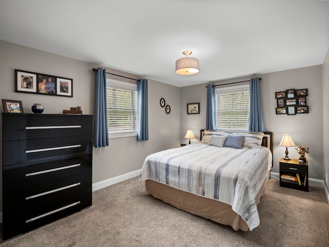 carpeted bedroom featuring baseboards