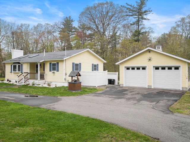 view of front of home featuring fence, a garage, a front yard, a chimney, and central AC unit