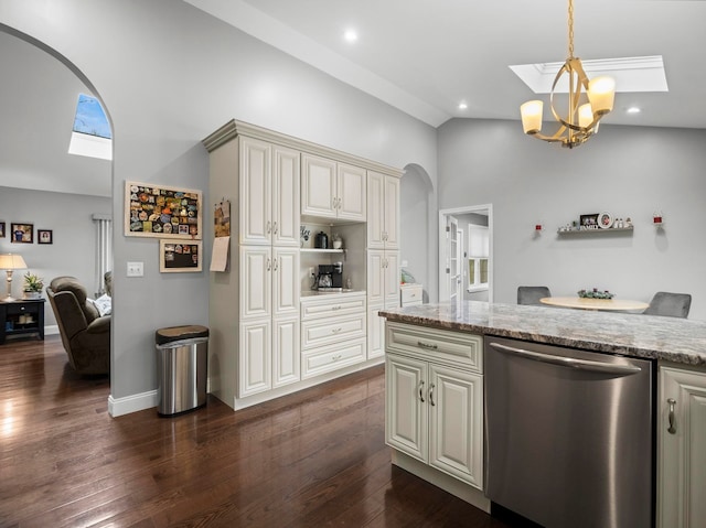 kitchen featuring a skylight, dark wood-style flooring, arched walkways, dishwasher, and light stone counters