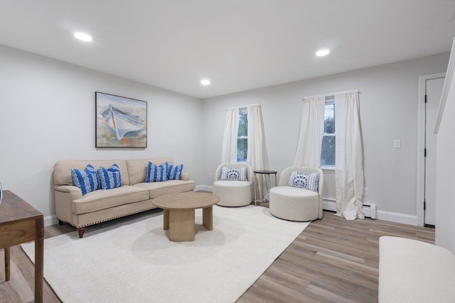 living room with baseboards, a baseboard radiator, recessed lighting, and wood finished floors