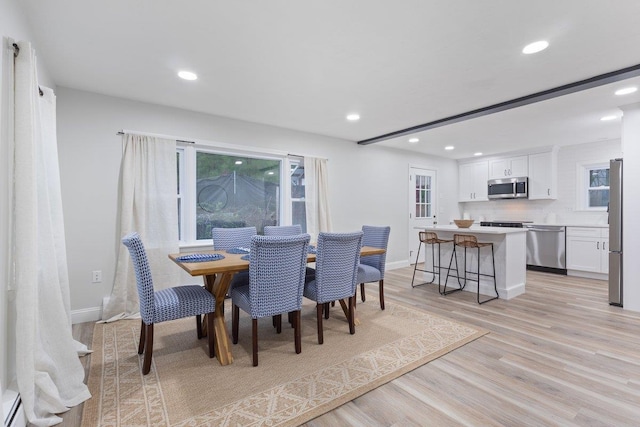 dining area with baseboards, light wood-type flooring, plenty of natural light, and recessed lighting