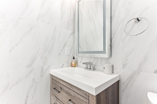 bathroom featuring tile walls and vanity