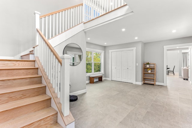 stairway with baseboards and recessed lighting