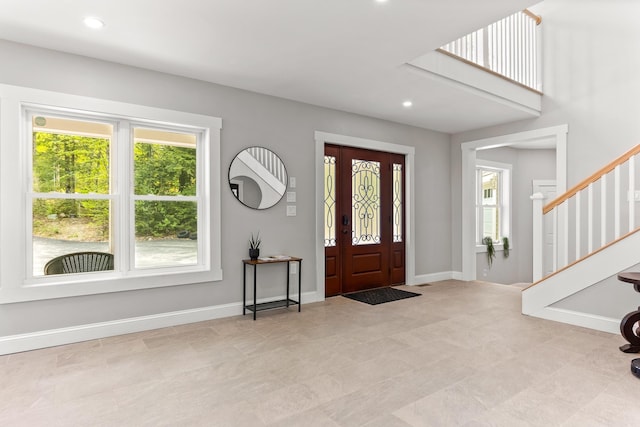 entryway featuring stairs, plenty of natural light, and recessed lighting