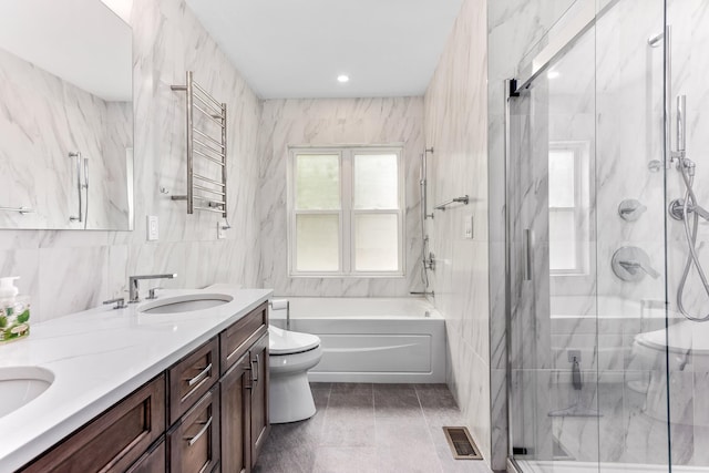 full bath with a stall shower, tile walls, toilet, visible vents, and a sink
