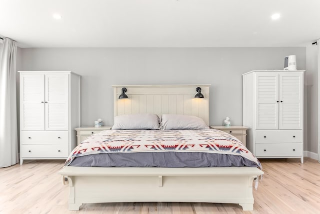 bedroom with light wood finished floors and recessed lighting