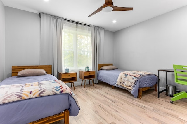 bedroom featuring wood finished floors, a ceiling fan, and recessed lighting