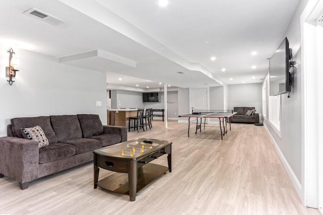living room with baseboards, recessed lighting, light wood finished floors, and visible vents