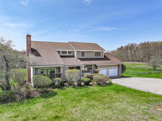 390 Bear Hill Rd, Loudon, NH 03307 - traditional home with a chimney, driveway, fence, a shingled roof, and a front yard