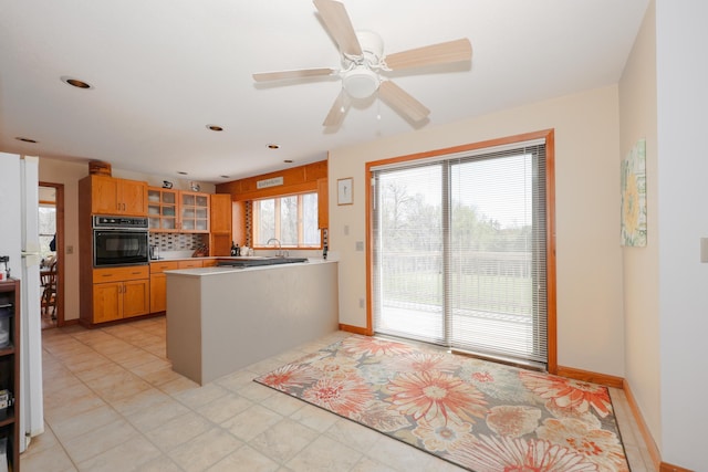 390 Bear Hill Rd, Loudon, NH 03307 - kitchen with a peninsula, glass insert cabinets, oven, baseboards, and ceiling fan
